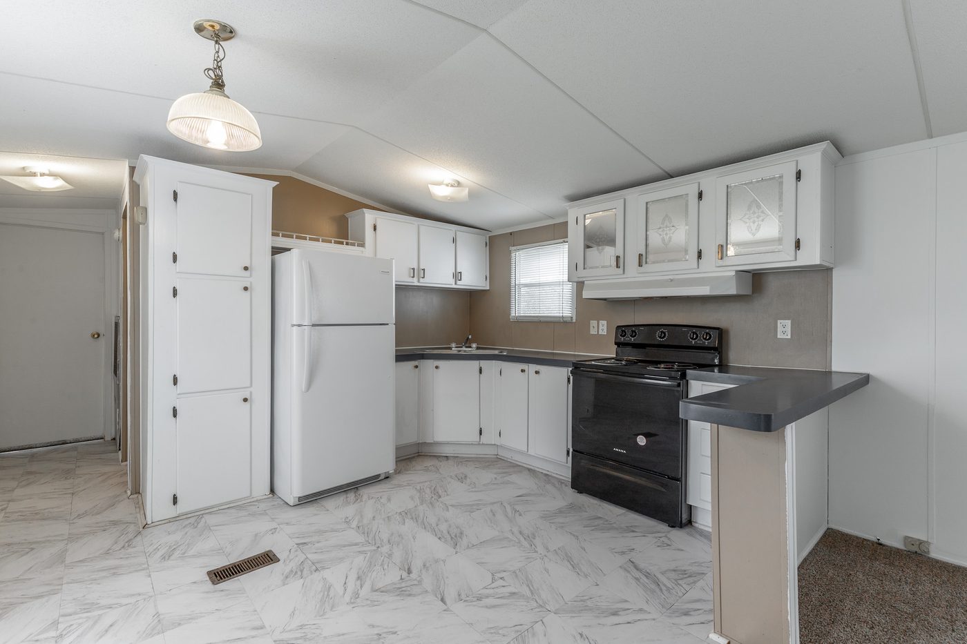 Kitchen after renovation, new tile floor and refreshed cabinets