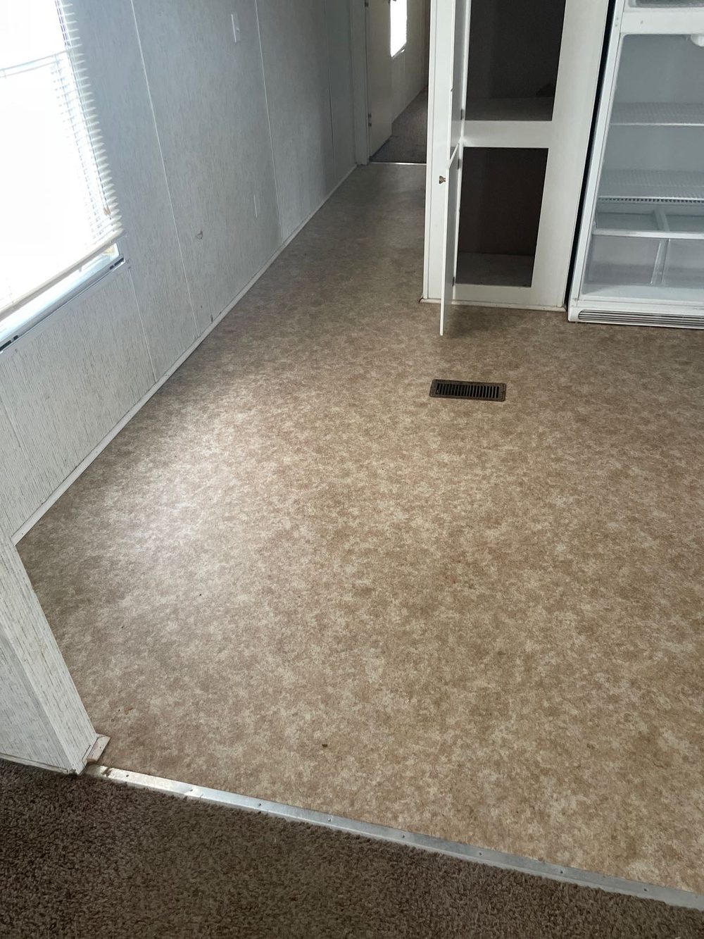 Before: kitchen cleanout, worn carpet and cabinets