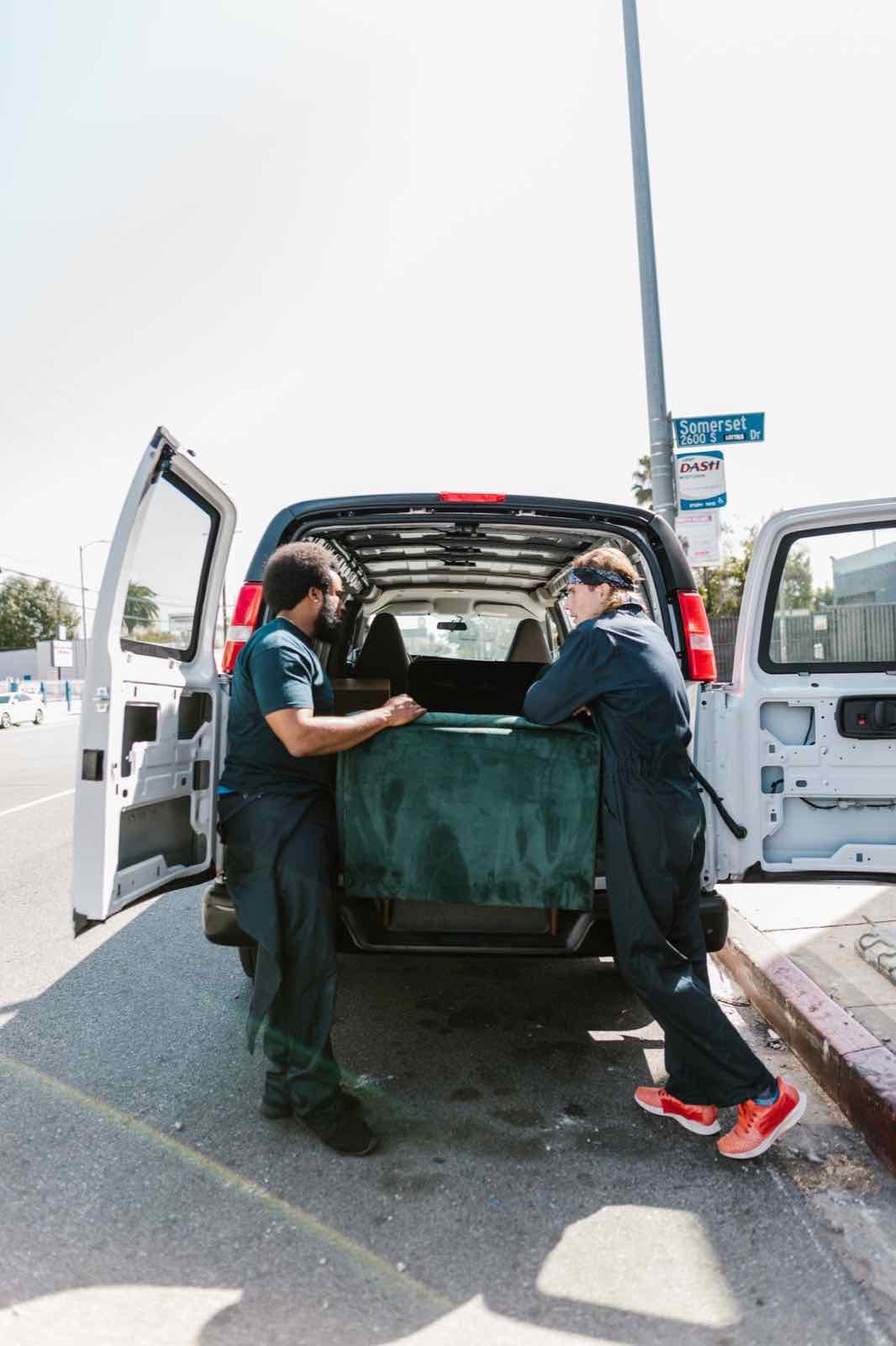 Crew loading furniture into a van during a property cleanout