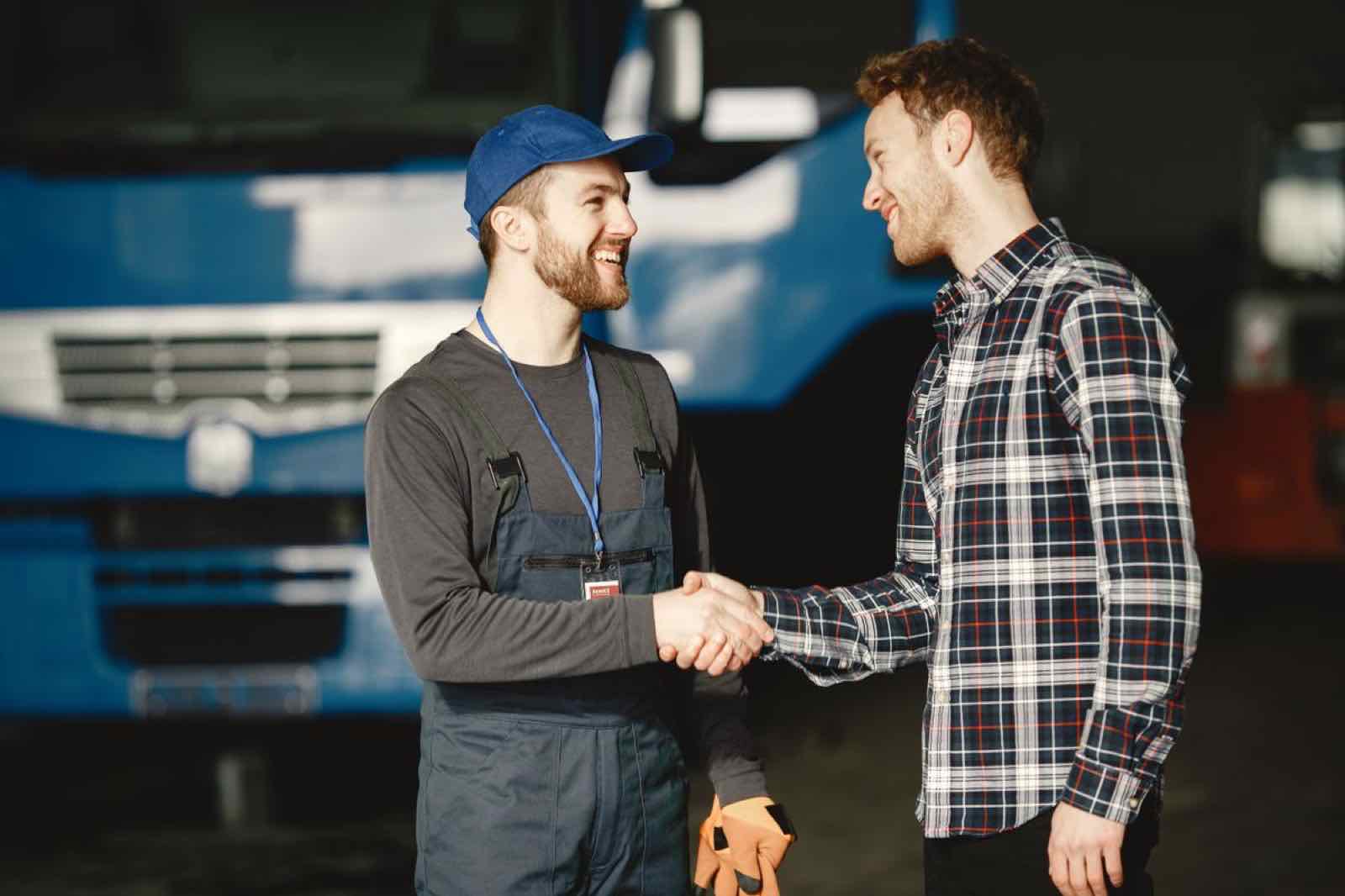 Tradesman shaking hands with a customer, symbolizing trust and service